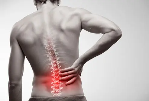 Physiotherapist helping a patient with back pain